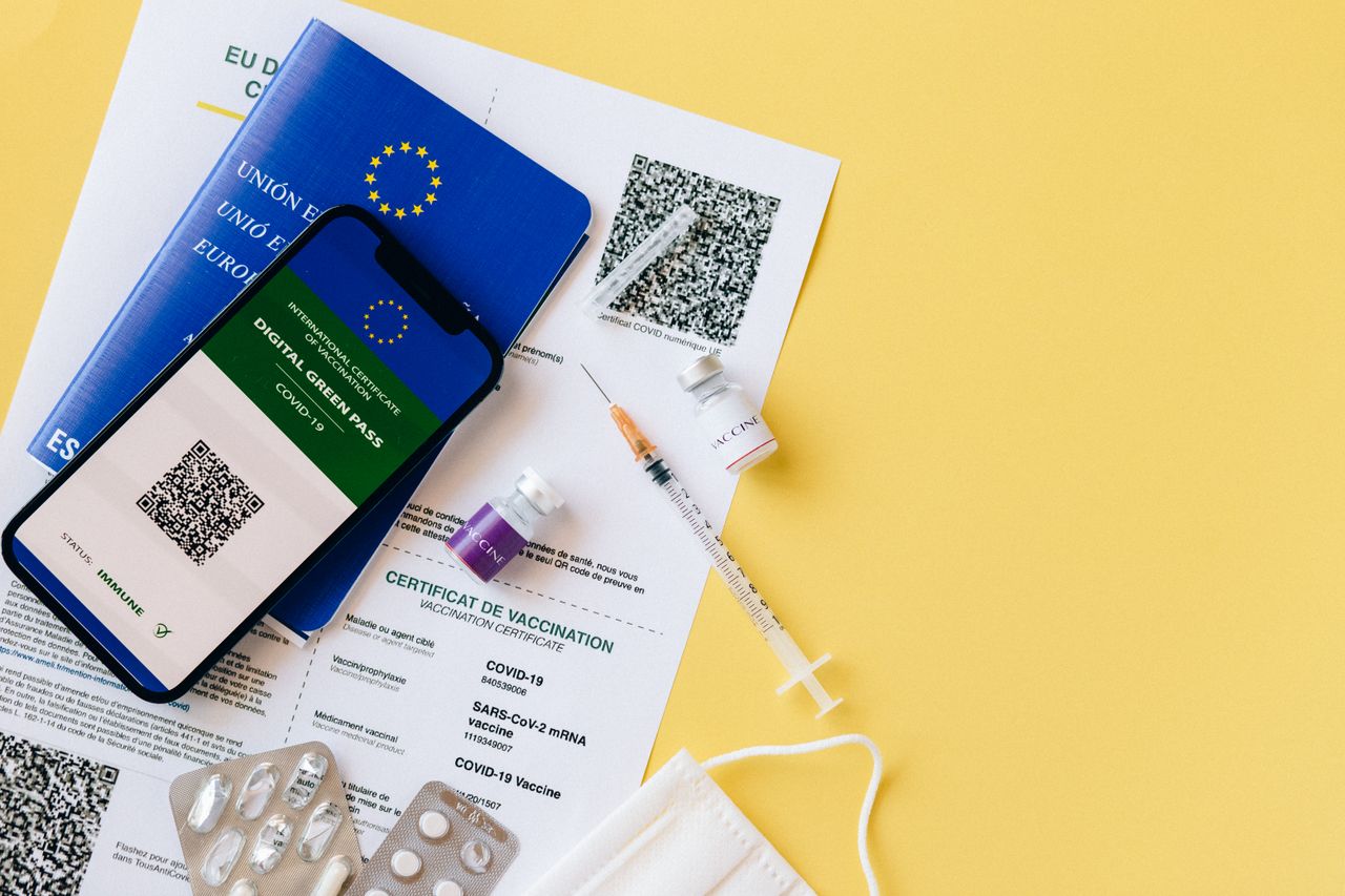 The Art of Drawing Readers In: Your attractive post title goes here Digital vaccine passport and COVID-19 vaccination items including syringes and masks on a yellow background.